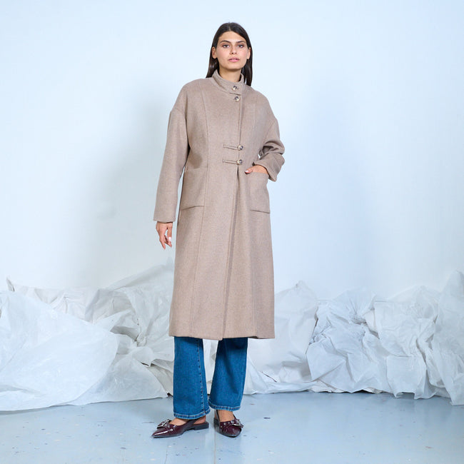 Taupe long coat with a stand collar and large patch pockets, front view