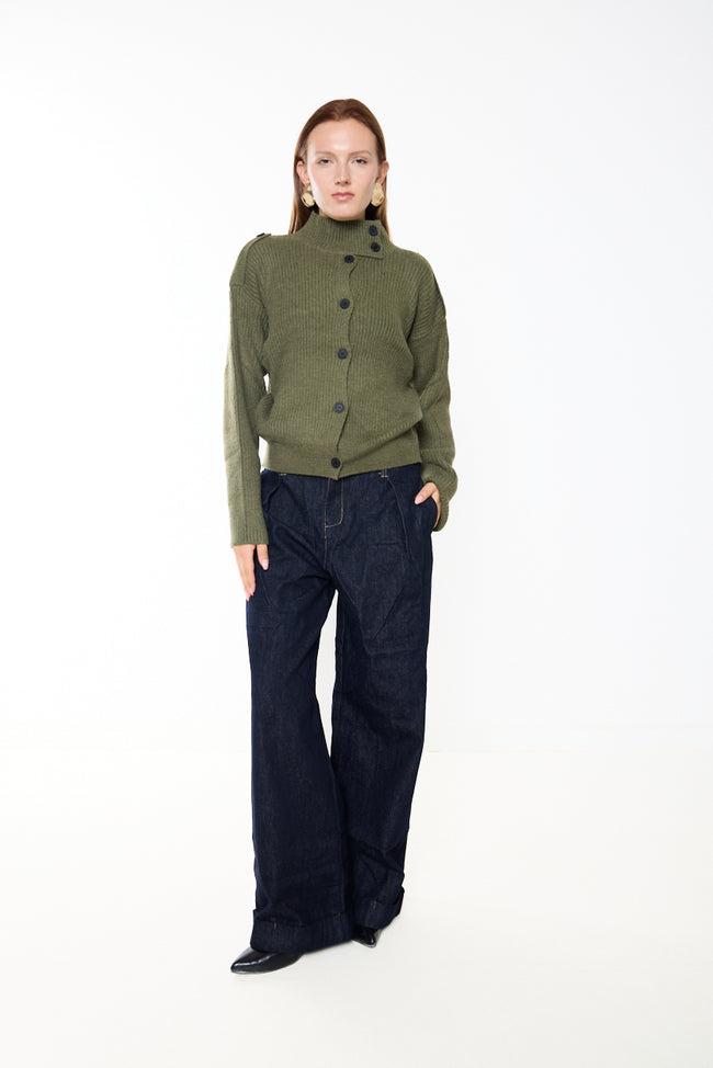 Olive green high-neck ribbed knit cardigan with asymmetric front button row, shoulder tabs, long sleeves and ribbed cuffs and hem; dark denim trousers and earrings styled separately