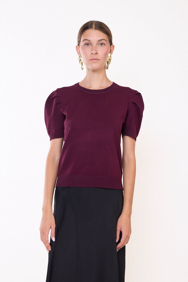 Bordeaux wine fine-knit round-neck sweater with short puff sleeves, pleated shoulder details, ribbed sleeve edges and ribbed hem; skirt and bangles styled separately